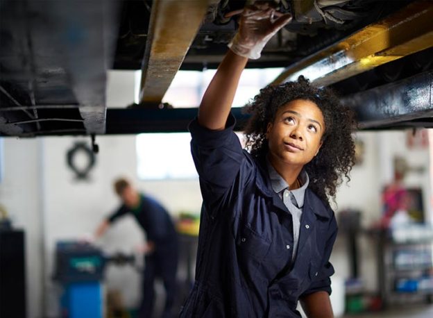 young mechanic working on a car